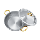 Mauviel M'ELITE B hammered 5-ply curved splayed saute pan with brass handles and lid for professional cooking.