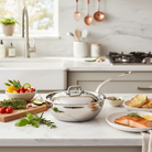 Mauviel M'ELITE hammered 5-ply stainless steel chef pan with curved lid and cast stainless steel handle, ideal for professional cooking.