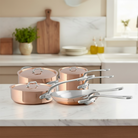 Mauviel M'3 S copper 10-piece cookware set with cast stainless steel handles, including pots and pans for versatile cooking.