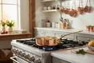 Mauviel M'Heritage M'150 B copper saute pan with brass handle and lid, showcasing its polished copper surface and sturdy construction