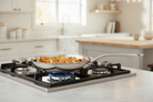 Mauviel M'COOK 5-ply stainless steel frying pan with cast stainless steel handle, showcasing a smooth, durable cooking surface.