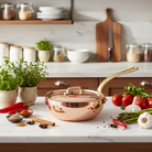 Mauviel M'Heritage M'200 B copper chef pan with brass handle and lid, showcasing its polished copper surface and sturdy metal handle.